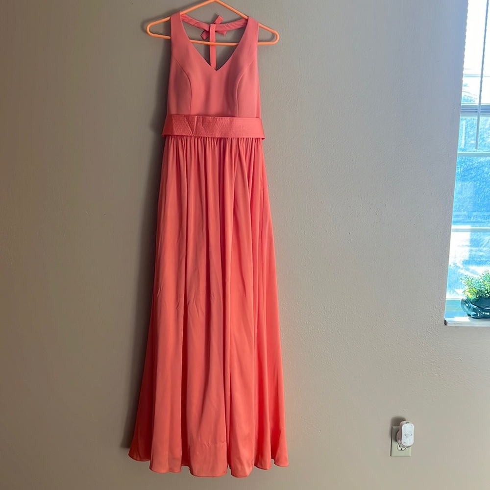Peach colored long dress with bow accents